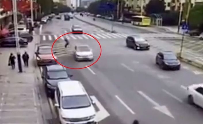 Çin’de yoğun trafikte yolun karşısına geçmek isteyen adam, hızla gelen